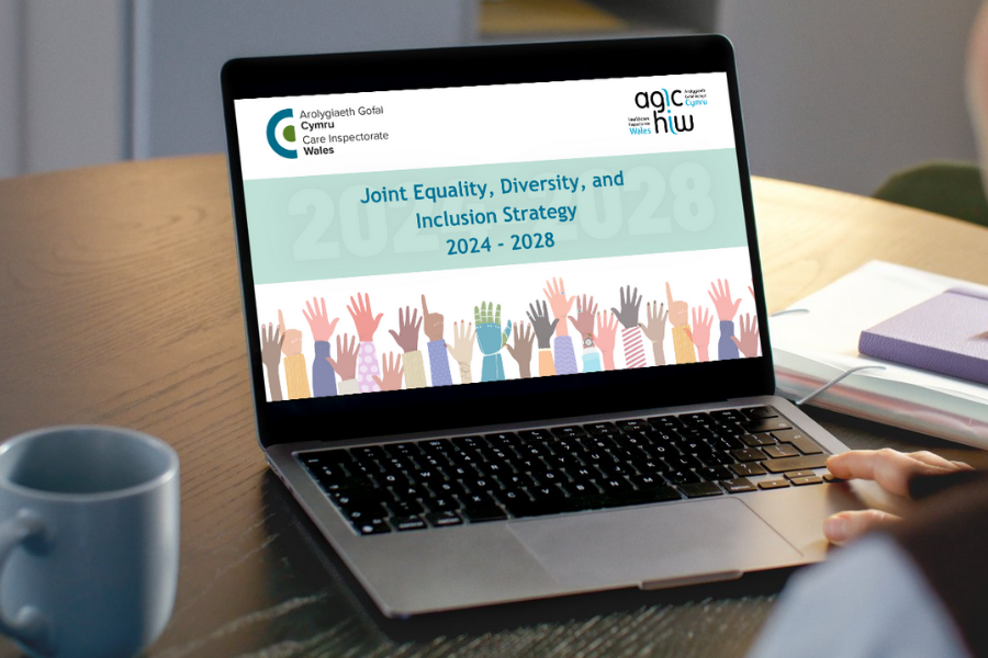 An image of a person with a laptop in front of them showing HIW's Joint Equality, Diversity, and Inclusion Strategy Plan
