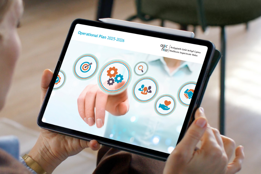 An image of a person holding a tablet showing HIW's Operational Plan cover